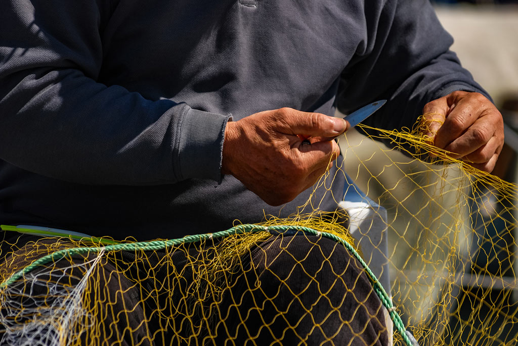 fisherman working on a net